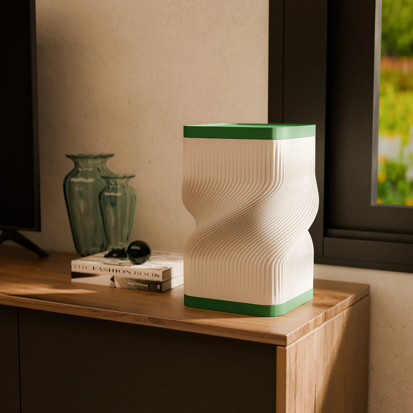 Decorative table lamp with wavy design on a wooden surface in a dimly lit room.