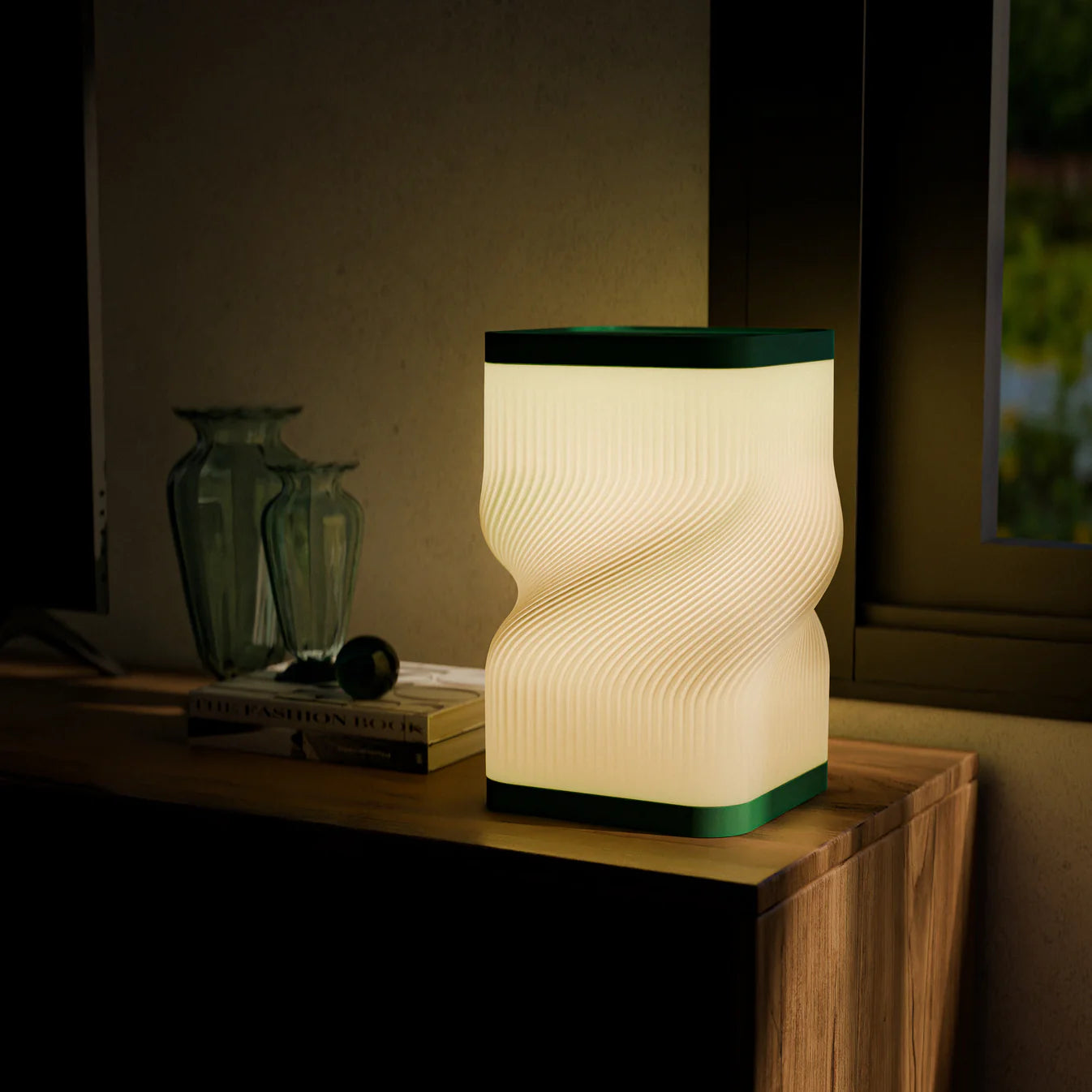 Decorative table lamp with wavy design on a wooden surface in a dimly lit room.